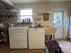 Laundry room with washer, dryer, utility sink, and exterior access at 535 S Peninsula Ave, New Smyrna Beach, FL 32169