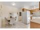 Bright kitchen with wood cabinets, white appliances, and a dining area at 535 S Peninsula Ave, New Smyrna Beach, FL 32169