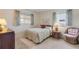 Cozy bedroom with a double bed and a wicker chair next to a window at 535 S Peninsula Ave, New Smyrna Beach, FL 32169