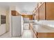 Bright kitchen with white appliances and wood cabinets at 535 S Peninsula Ave, New Smyrna Beach, FL 32169