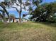 Large grassy backyard with mature trees at 535 S Peninsula Ave, New Smyrna Beach, FL 32169