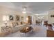 Living room with a sofa, coffee table, and access to the dining area at 535 S Peninsula Ave, New Smyrna Beach, FL 32169