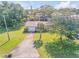 Aerial view of a single story home with a large yard and driveway at 535 S Peninsula Ave, New Smyrna Beach, FL 32169