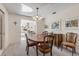 Dining room with a wood table and chairs, adjacent to the living room at 535 S Peninsula Ave, New Smyrna Beach, FL 32169