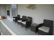 Front porch with wicker chairs and a side table at 806 South St, New Smyrna Beach, Fl 32168, FL 32168
