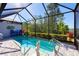 Inviting screened-in pool with a mermaid statue and seating at 933 Attitude Ave, Daytona Beach, FL 32124