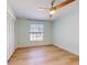 Light and bright bedroom with wood-look flooring and a double door closet at 6180 Olympic Ct, Port Orange, FL 32127