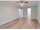 Main bedroom with light walls, hardwood floors, and ensuite bathroom at 6180 Olympic Ct, Port Orange, FL 32127