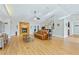 Living room with hardwood floors, stone fireplace, and a view into the kitchen at 756 Bay Dr, New Smyrna Beach, FL 32168