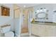 Bathroom with shower, granite vanity, and decorative mirror at 756 Bay Dr, New Smyrna Beach, FL 32168
