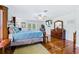 Main bedroom with king bed, hardwood floors, and TV at 756 Bay Dr, New Smyrna Beach, FL 32168