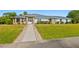 House exterior, light blue with stone accents, and a walkway at 756 Bay Dr, New Smyrna Beach, FL 32168