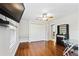 Spacious bedroom with wood floors, large TV, and built in shelving at 756 Bay Dr, New Smyrna Beach, FL 32168