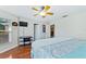 Bedroom with king-size bed, wood floors, and large window at 756 Bay Dr, New Smyrna Beach, FL 32168