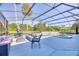 Relaxing pool area with covered patio, seating, and lush landscaping at 756 Bay Dr, New Smyrna Beach, FL 32168