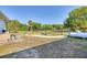 Landscaped side yard with a garden and propane tank at 756 Bay Dr, New Smyrna Beach, FL 32168
