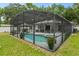 Screened-in pool and spa with patio furniture at 1328 Needle Palm Dr, Edgewater, FL 32132