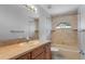 Clean bathroom with beige tile, a bathtub, and a vanity with a sink at 1328 Needle Palm Dr, Edgewater, FL 32132