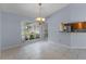 Spacious dining area with large window and chandelier at 1328 Needle Palm Dr, Edgewater, FL 32132
