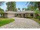 One-story home with brick facade and paver driveway at 1328 Needle Palm Dr, Edgewater, FL 32132