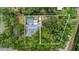 Aerial view showing house, pool, and large lot at 1328 Needle Palm Dr, Edgewater, FL 32132