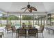 Covered patio with table and chairs, overlooking the pool at 1328 Needle Palm Dr, Edgewater, FL 32132