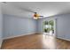 Spacious bedroom with laminate wood flooring and sliding doors to patio at 1328 Needle Palm Dr, Edgewater, FL 32132