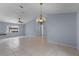 Open dining area with tile floors and chandelier at 1328 Needle Palm Dr, Edgewater, FL 32132