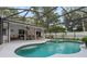 Screened-in pool and spa with patio furniture at 1328 Needle Palm Dr, Edgewater, FL 32132