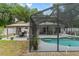 Inviting backyard oasis featuring a pool, screened enclosure, and gazebo at 1328 Needle Palm Dr, Edgewater, FL 32132