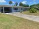 Ranch style home with carport and mature landscaping at 1846 Royal Palm Dr, Edgewater, FL 32141