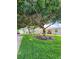 Condo building with mature landscaping and a large tree at 2100 N Peninsula Ave # 1050, New Smyrna Beach, FL 32169