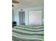 Bedroom with striped bedding and large closet at 2100 N Peninsula Ave # 1050, New Smyrna Beach, FL 32169