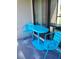 Small patio with blue table and chairs at 2100 N Peninsula Ave # 1050, New Smyrna Beach, FL 32169