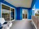 Spacious balcony with sliding glass doors and blue walls at 1 Riverwalk Dr # 202, New Smyrna Beach, FL 32169