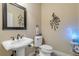 Stylish powder room with pedestal sink, decorative art, and modern fixtures at 5090 Riverside Dr # 105, Port Orange, FL 32127