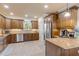 Spacious kitchen with wood cabinets, granite counters, and stainless steel appliances at 5090 Riverside Dr # 105, Port Orange, FL 32127
