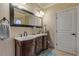 Elegant bathroom featuring a double vanity, large mirror, and ample storage at 5090 Riverside Dr # 105, Port Orange, FL 32127