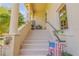 Ground level entrance with steps, a small patio, and landscaping at 5090 Riverside Dr # 105, Port Orange, FL 32127
