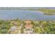 Aerial view of waterfront property with lush landscaping and a main house at 5090 Riverside Dr # 105, Port Orange, FL 32127
