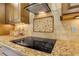 Modern cooktop with granite countertop and tile backsplash at 5090 Riverside Dr # 105, Port Orange, FL 32127