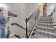 Elegant staircase with wrought-iron railing and patterned carpet runner at 5090 Riverside Dr # 105, Port Orange, FL 32127