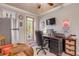 Home office features a desk, seating, and access to an outdoor patio at 5090 Riverside Dr # 105, Port Orange, FL 32127