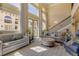 Bright living room with high ceilings, large windows, and comfortable seating at 5090 Riverside Dr # 105, Port Orange, FL 32127
