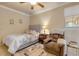 Charming bedroom with a bed, chair, and window at 5090 Riverside Dr # 105, Port Orange, FL 32127