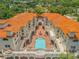 Complex with orange tile roofs and central courtyard pool at 5090 Riverside Dr # 105, Port Orange, FL 32127