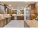 Modern kitchen featuring granite countertops and wood cabinets at 5090 Riverside Dr # 105, Port Orange, FL 32127