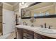 Elegant bathroom featuring a double vanity, large mirror, and ample storage at 5090 Riverside Dr # 105, Port Orange, FL 32127