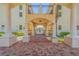Covered walkway with arches and wrought-iron gate leading to a courtyard at 5090 Riverside Dr # 105, Port Orange, FL 32127