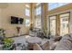 Sunlit living room with hardwood floors and access to balcony at 5090 Riverside Dr # 105, Port Orange, FL 32127